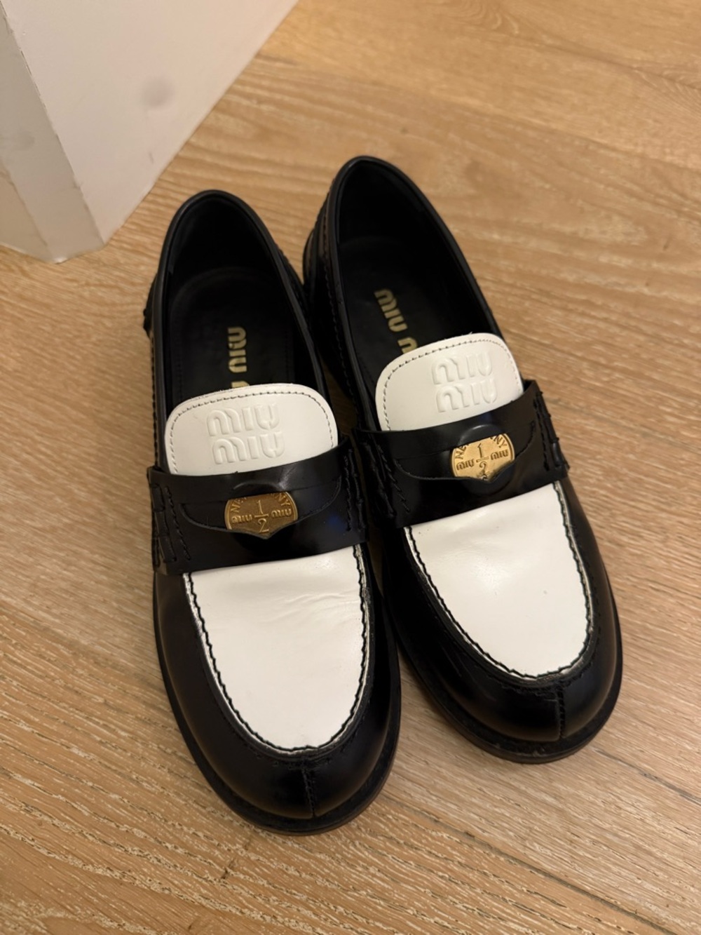 Miu Miu Black and White Leather Penny Loafers with Gold-Tone Hardware